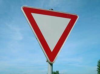 Road sign for the question: A yield sign is which shape and colour?